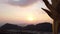 View among Buddha statuettes at beautiful colourful sunset sky and mountains in Tiger Cave Temple