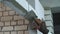 View of builder hand in glove putting adhesive mixturer on blocks at doorway