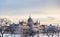 View of the building of the Hungarian Parliament illuminated by the rays of the setting sun. In Budapest, Hungary