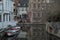 View of buildings and boats by waterway n Bruges