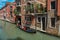 View of buildings in front of the canal with gondola in Venice.