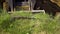 View of bulldozer bucket digging trench in grassy soil during earth works