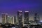 The view of business buildings is decorated with glittering night lights in the city of Jakarta, isolated from the nuances of star