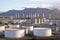 view of busy oil refinery, with huge storage tanks and pipes visible