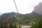 View from the cable car cabin to the village in the mountains and the Dolomites in Italy. Selective focus