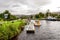 A view of Caledonian Canal with a couple of boats parked near locks from Loch Ness entrance, Fort Augustus, Scotland