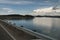 View of a calm and serene lake with approaching storms