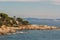 View of Cami Ronda de S'Agaro a Sa Conca S'Agaro with rocks on the beach in Spain