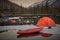 View of camp life in a mountain terrain. Lake shore with canoe