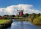 View From A Canal Bridge To The Famous Twin Mills Of Greetsiel East Frisia