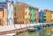 View of the canal with moored boats, colorful houses in one of the Italian towns
