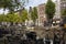 View of canal, parked boats, cars and bicycles