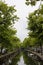 View of canal, trees and bridge in Edam.