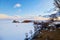 View of Cape Burhan or Shaman rock on Olkhon island in winter. Frozen Lake Baikal.