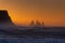 View from cape Dyrholaey on Reynisfjara Beach and Reynisdrangar basalt sea stacks, Iceland. Stormy sunrise