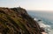 View of Cape Roca with red lighthouse - Sintra Portugal. Travel and tourism landmark with beautiful coastline cliffs of atlantic