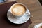 View of cappuccino served on wooden table