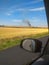 View from the car. Fire in field after wheat harvest in summer. Large explosion