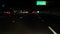 View from the car. Los Angeles busy freeway at night time. Massive Interstate Highway Road in California, USA. Auto driving fast