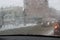 View from the car windscreen during rain and wet snow. Poor visibility while driving around the city. Snowy road