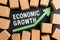 view Cardboard boxes with green chart arrow, economic growth concept