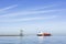 View of the cargo and liquefied petroleum gas ship near to pier and cloudy sky.