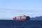 A View of Cargo ship `Yang Ming` full of containers near Vancouver at sunny day