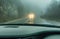 View through the cars windshield in the winter fog on the road