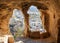 View through carved cave window. Church of St. John the Baptist in Cavusin. Cappadocia. Turkey