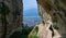 View from carved in rock path to clifftop monastery over Kalambaka and Kastraki villages at foot of Meteora mountains