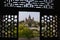 View from a carved window of Raj Mahal. Chaturbhuj temple is seen in the distance. Orchha. Madhya Pradesh.