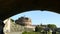 View of Castel Sant`Angelo from a bank of the Tiber river, framed by the shadow of a bridge