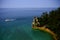 View of castle rock at pictured rocks with a boat passing by