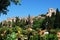 View of the castle seen from the Pedro Luis Alonso gardens, Malaga, Spain.