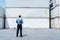 View of Caucasian Cargo Container Site Manager Against Stack of  White Container Cargo