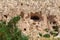 View of cave house from Cappadocia. Impressive fairy chimneys of sandstone in the canyon near Cavusin village, Cappadocia