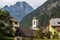 View on Central Parish Church and Buildings of Log pod Mangartom with Mount Rombon in the Background. Bovec, Slovenia, Europe