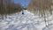 View from chair lift on ski slope with trees covered with snow