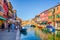 view of a channel on murano island in italy which is surrounded with tourist shops selling famous murano glass...IMAGE