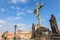 View of Charles Bridge statues and crucifix, Prague Castle in Prague, Czech Republic. Nice sunny summer day with blue sky and clou