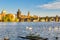 View on Charles bridge and Swans on Vltava river in Prague at sunset, Czech Republic