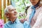 View of cheerful retired woman standing near happy senior husband