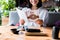 View of cheerful woman sitting in sushi bar and holding menu