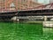 View of Chicago River after being dyed green for St. Patrick& x27;s Day, with snow showers coming down