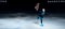 View of child  figure skater on dark ice arena