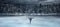 View of child figure skater on winter lake