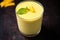 view of a chilled glass of mango lassi from the top angle