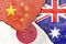 View of China Australia Japan flags icon on weathered cracked wall background
