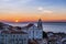 View of a Church in the Alfama neighborhood from the Portas do Sol viewpoint at sunrise in Lisbon, Portugal