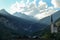 A view on the church in Heiligenblut in Austria. The church is surrounded by tall Alpine peaks. Few sunbeams coming to the valley.